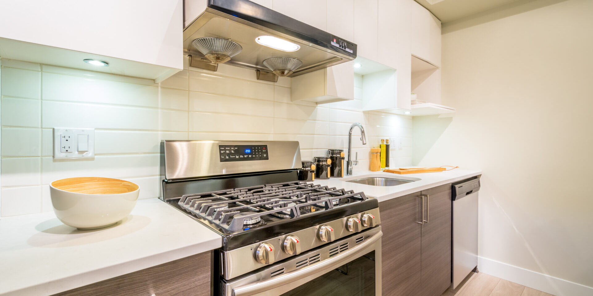 Modern, Bright, Clean Kitchen Interior With Stainless Steel Appliances In A Luxury Apartment.