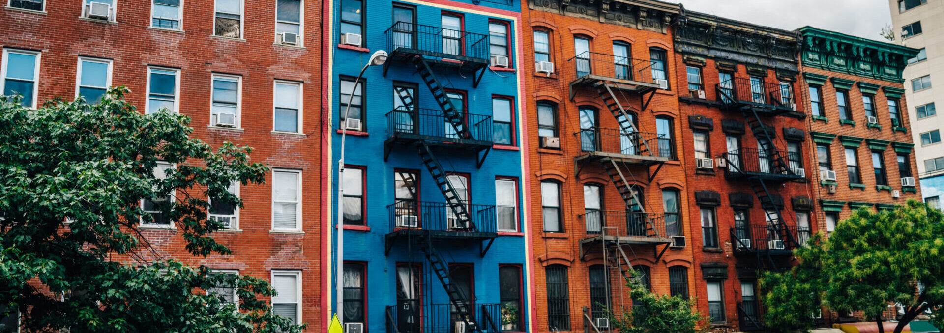 Beautiful Cityscape Of Vintage Colourful Building With Fire Escape From Residential Flats And Commercial Real Estate On Ground Floor,old Houses In Brooklyn District With Rental Apartments For Living.
