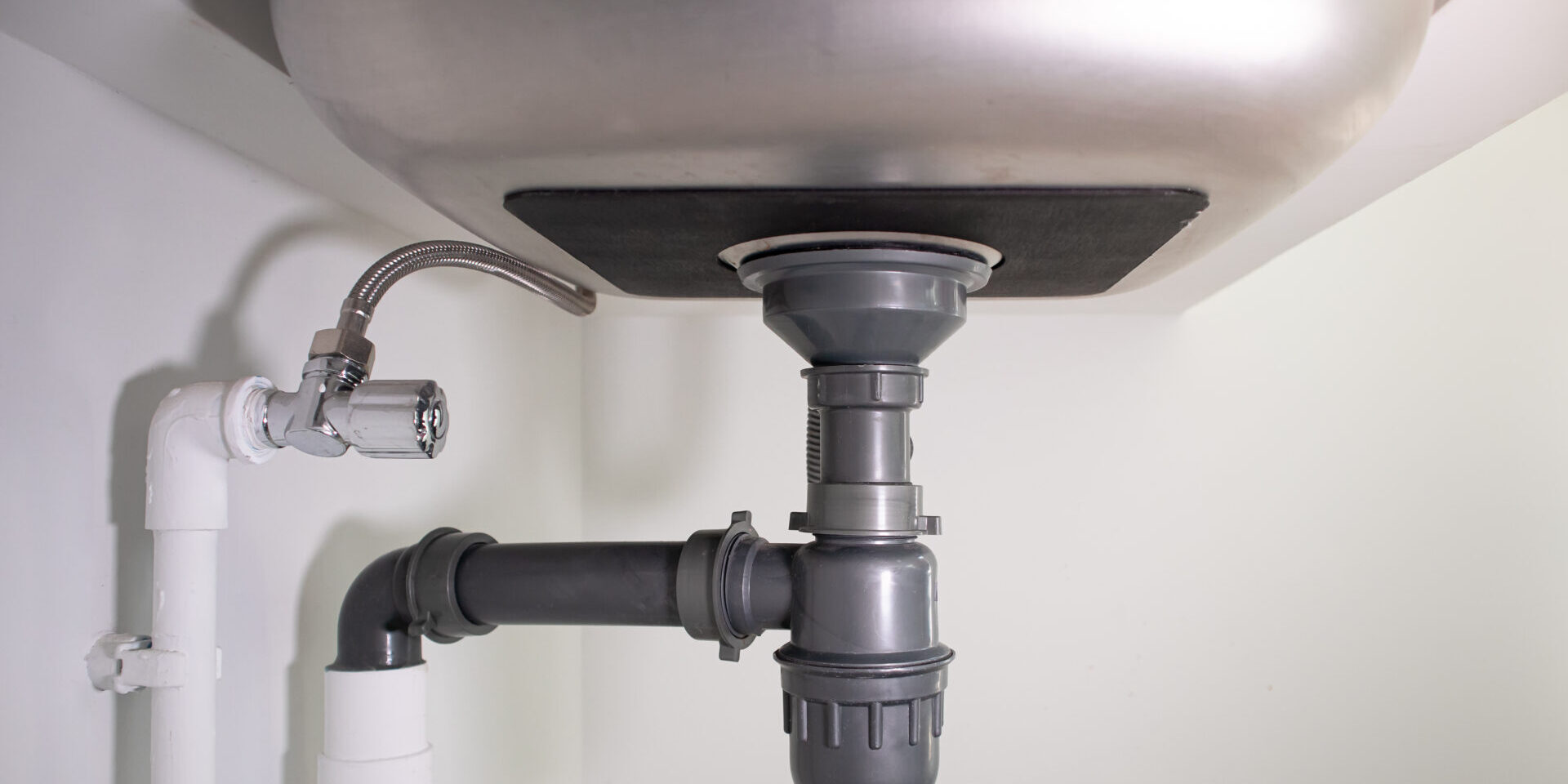 Water Drain Pipe Under Kitchen Sink And Faucet.
